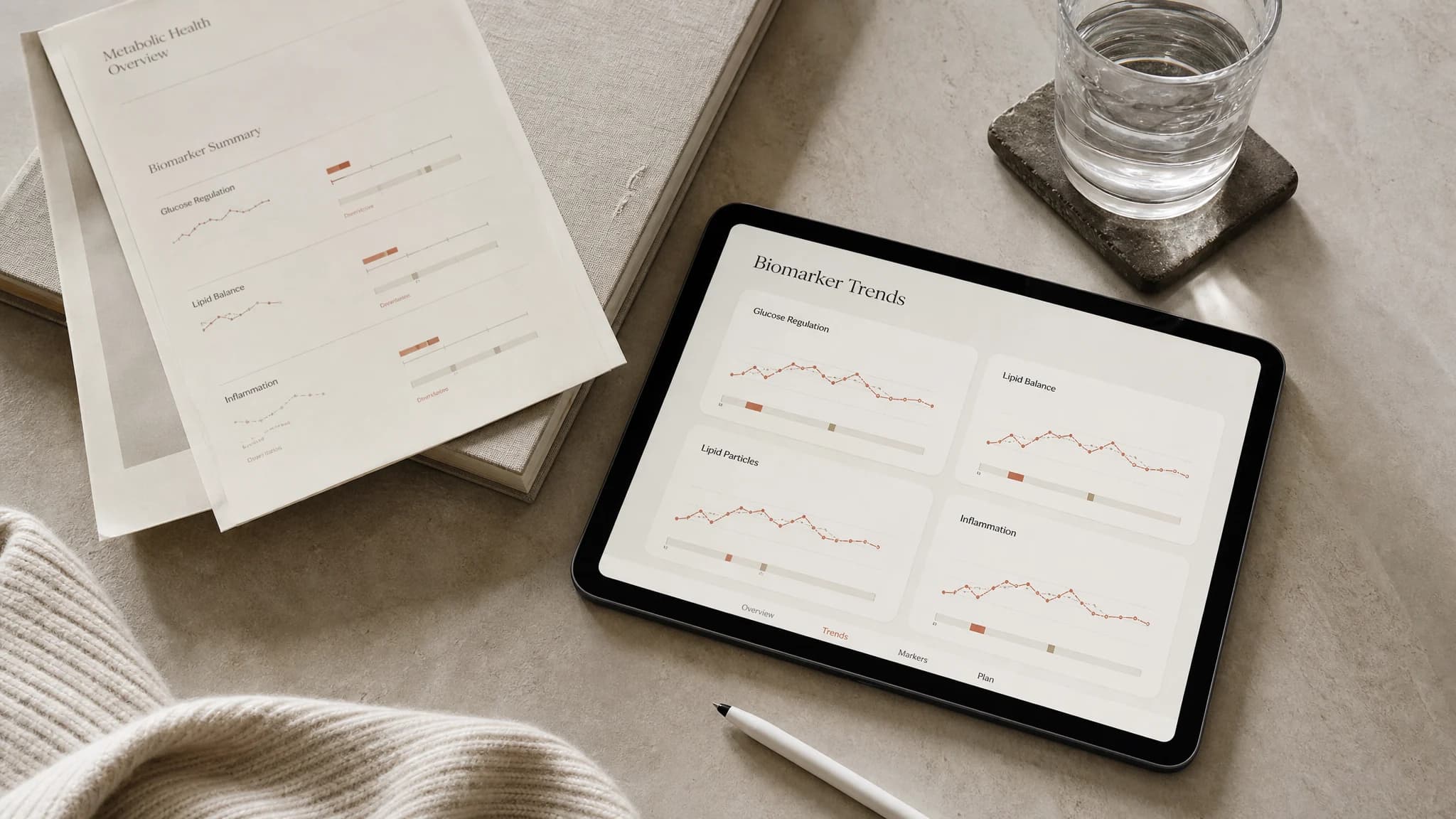 Biomarker trends on a tablet beside a printed baseline report